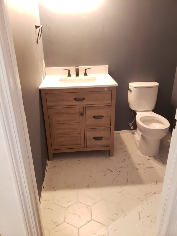 after bathroom remodel, vanity, faucet and toilet installation